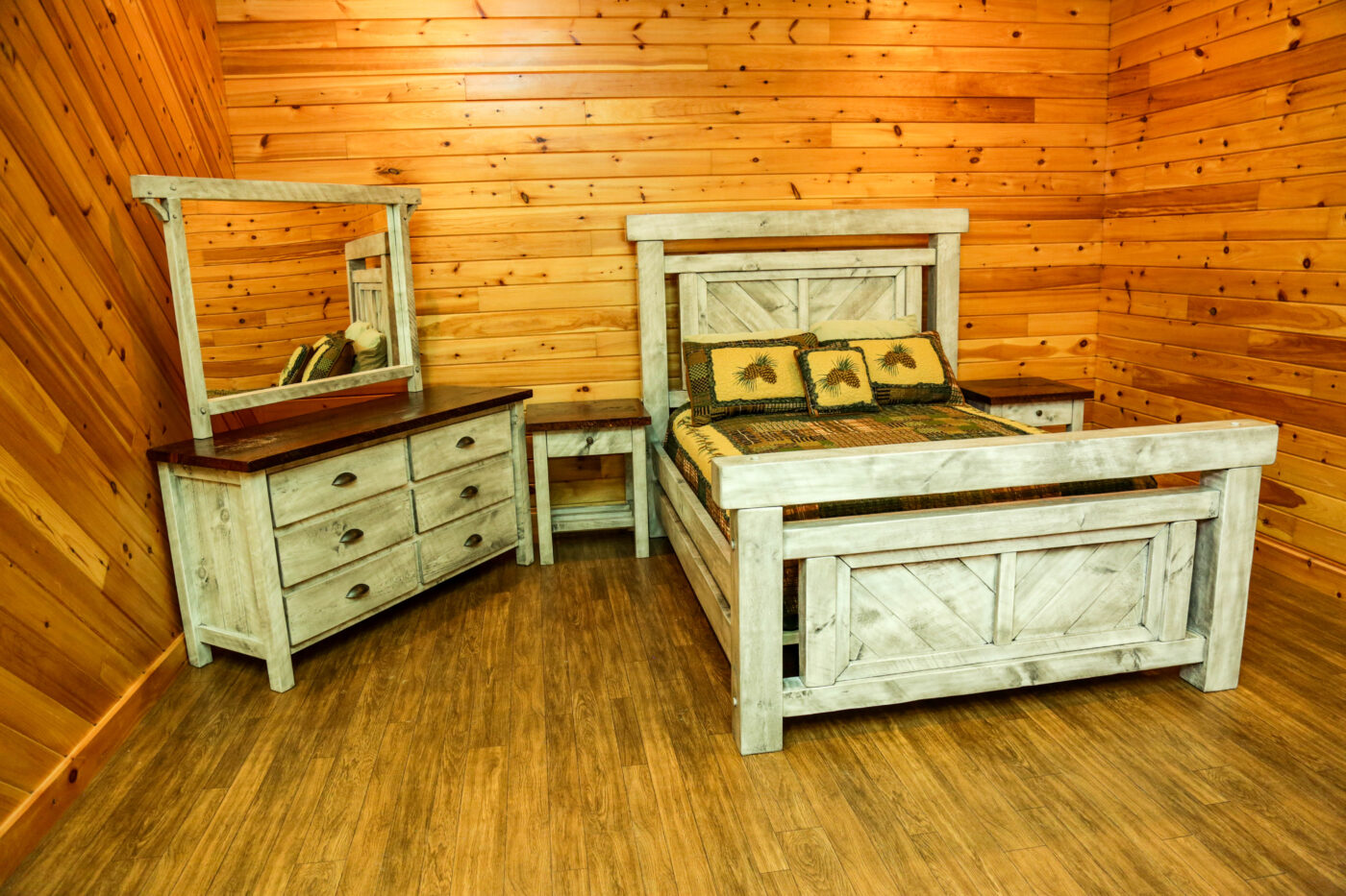 Rustic Timber Peg wooden bedroom set featuring a bed, dresser with dark wood top and mirror, and matching side tables, showcasing a distressed farmhouse-style finish